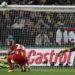 Ghana's Asamoah Gyan, right, misses on a penalty shot as Uruguay goalkeeper Fernando Muslera, bottom left, looks up during the World Cup quarterfinal soccer match between Uruguay and Ghana at Soccer City in Johannesburg, South Africa, Friday, July 2, 2010. (AP Photo/Luca Bruno)